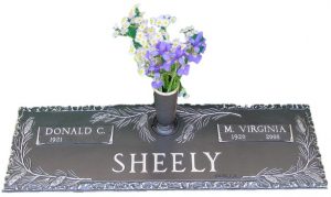 Bronze cemetery marker with pine bow and vase