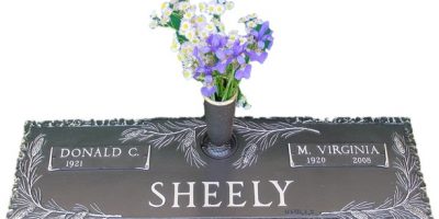 Bronze cemetery marker with pine bow and vase